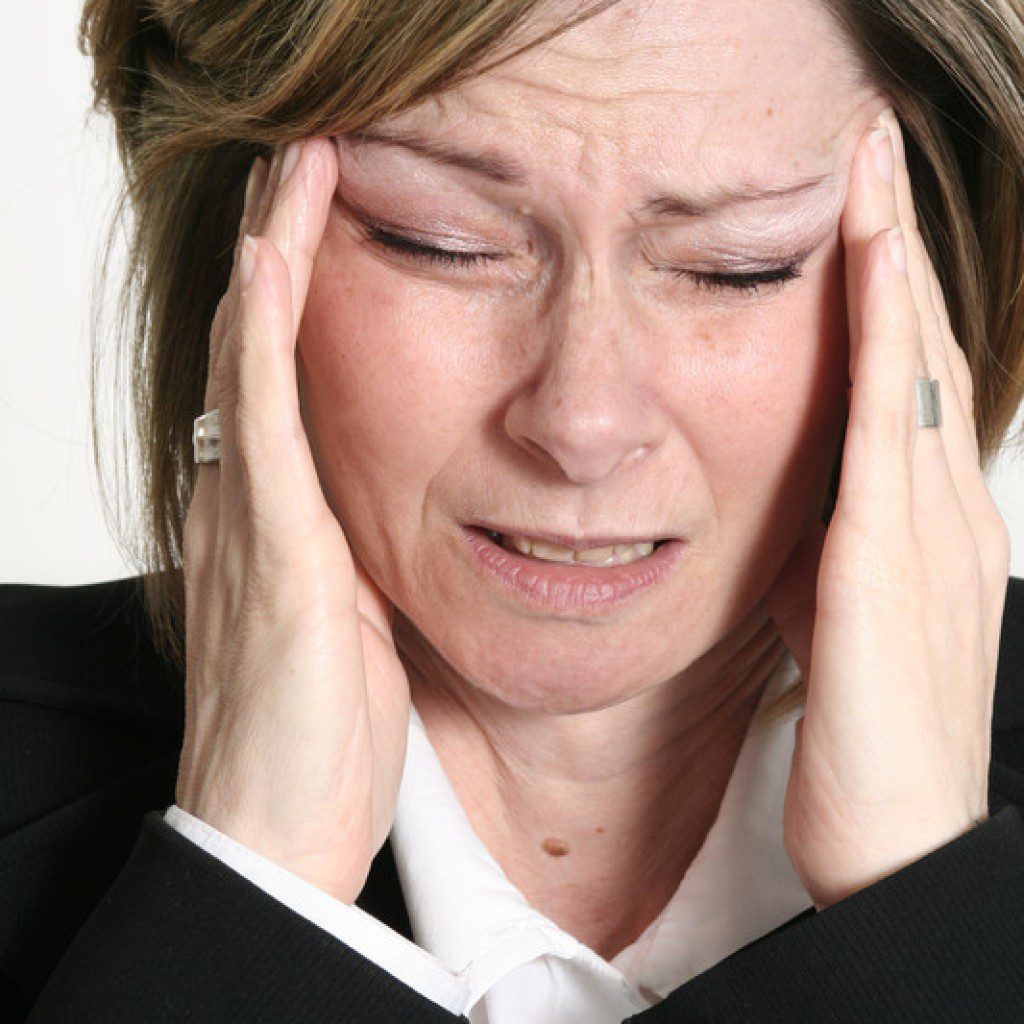 picture of a woman with headaches and migraines premenstrual menopause